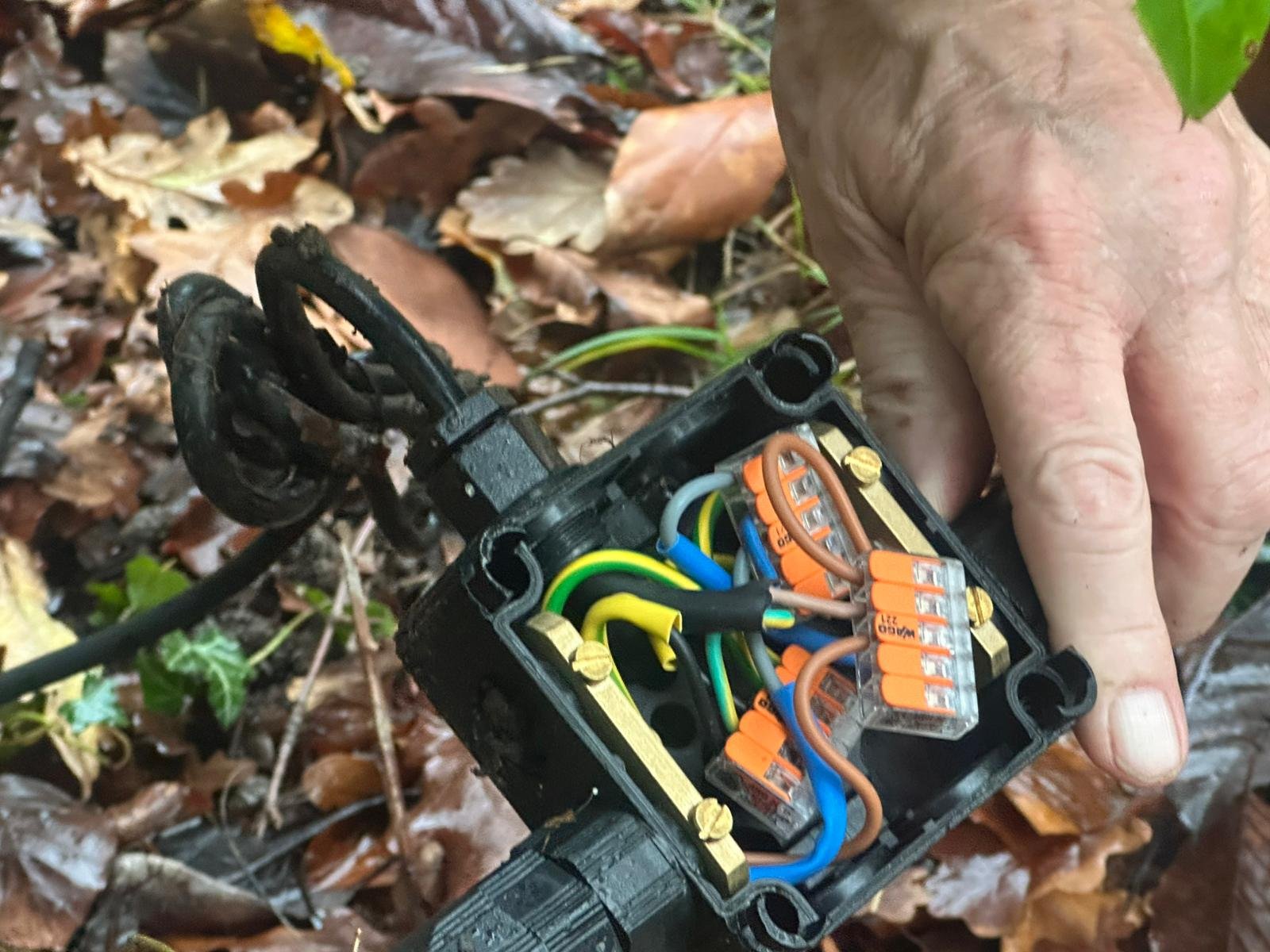 Cable being tested inside a wall box