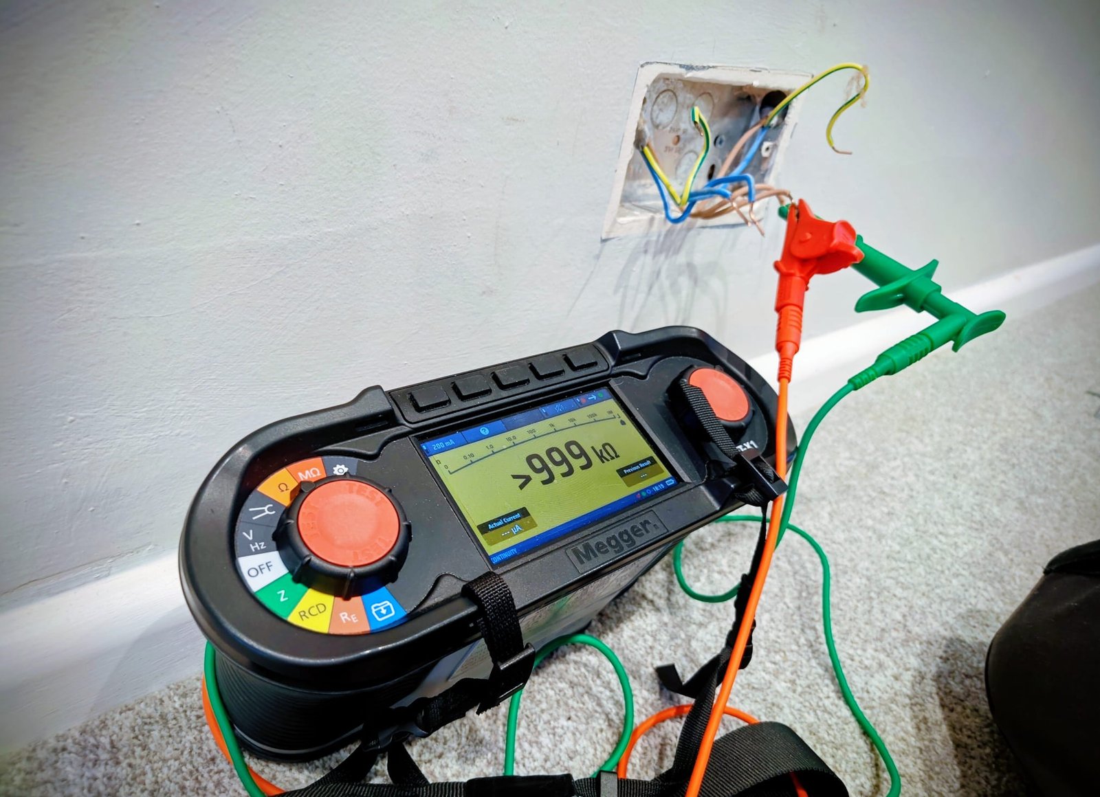 Multimeter being used on a lighting circuit