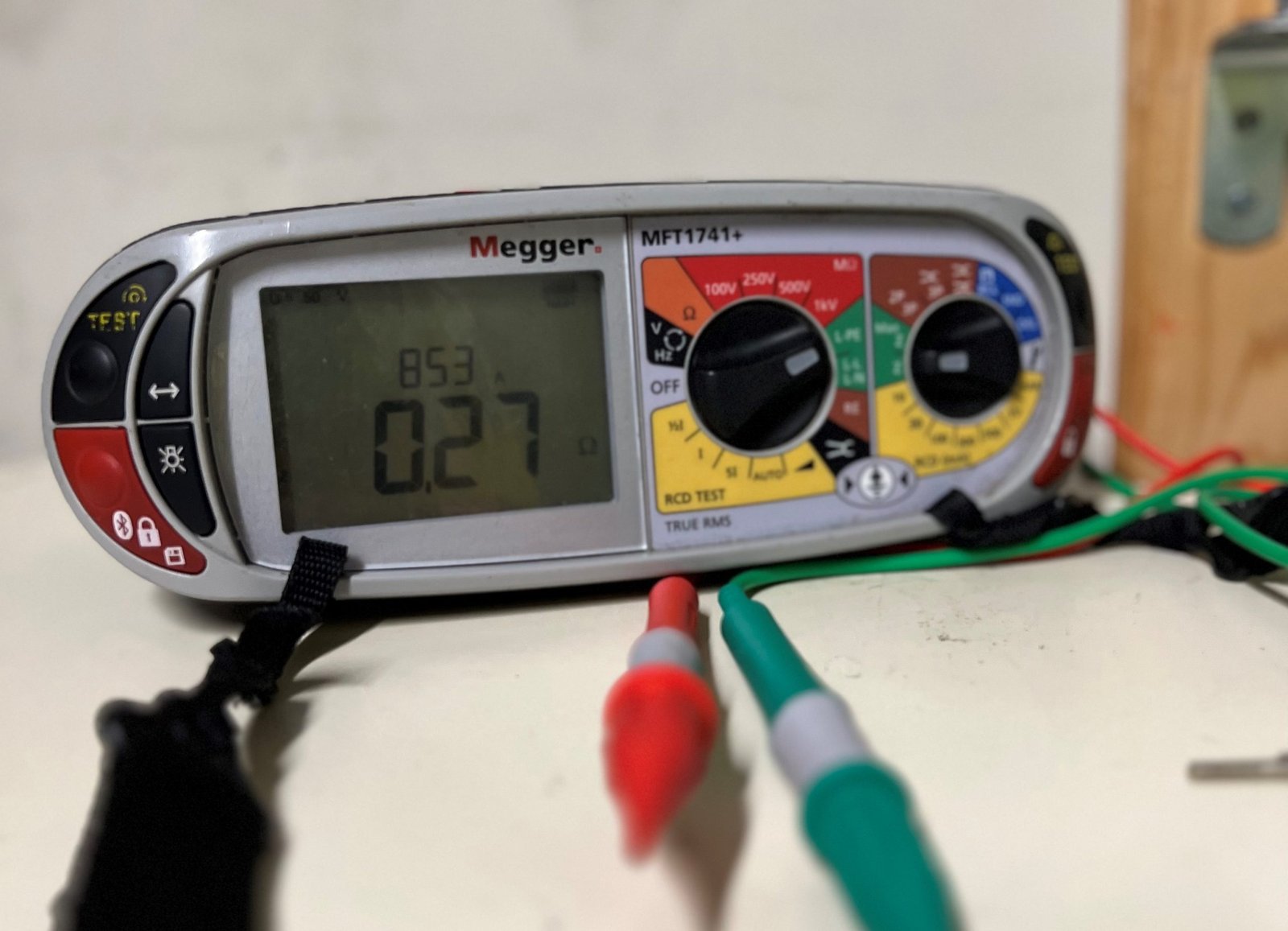 Electrician testing a consumer unit by torchlight