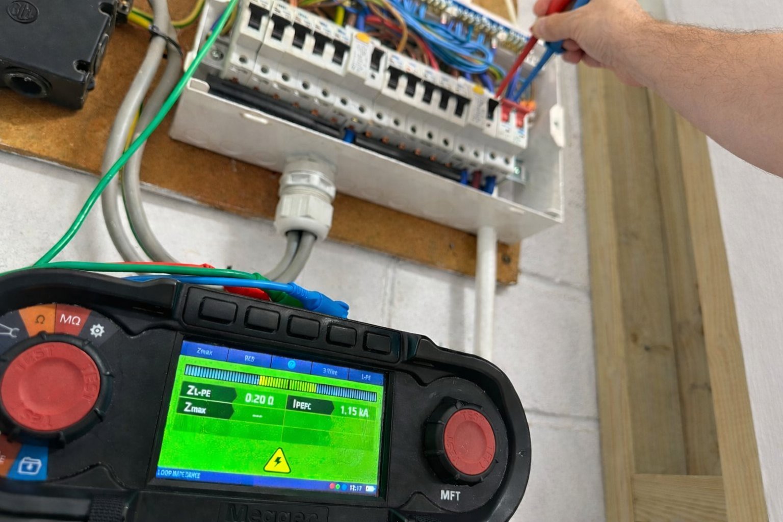 Inspector recording circuit observations on an EICR schedule